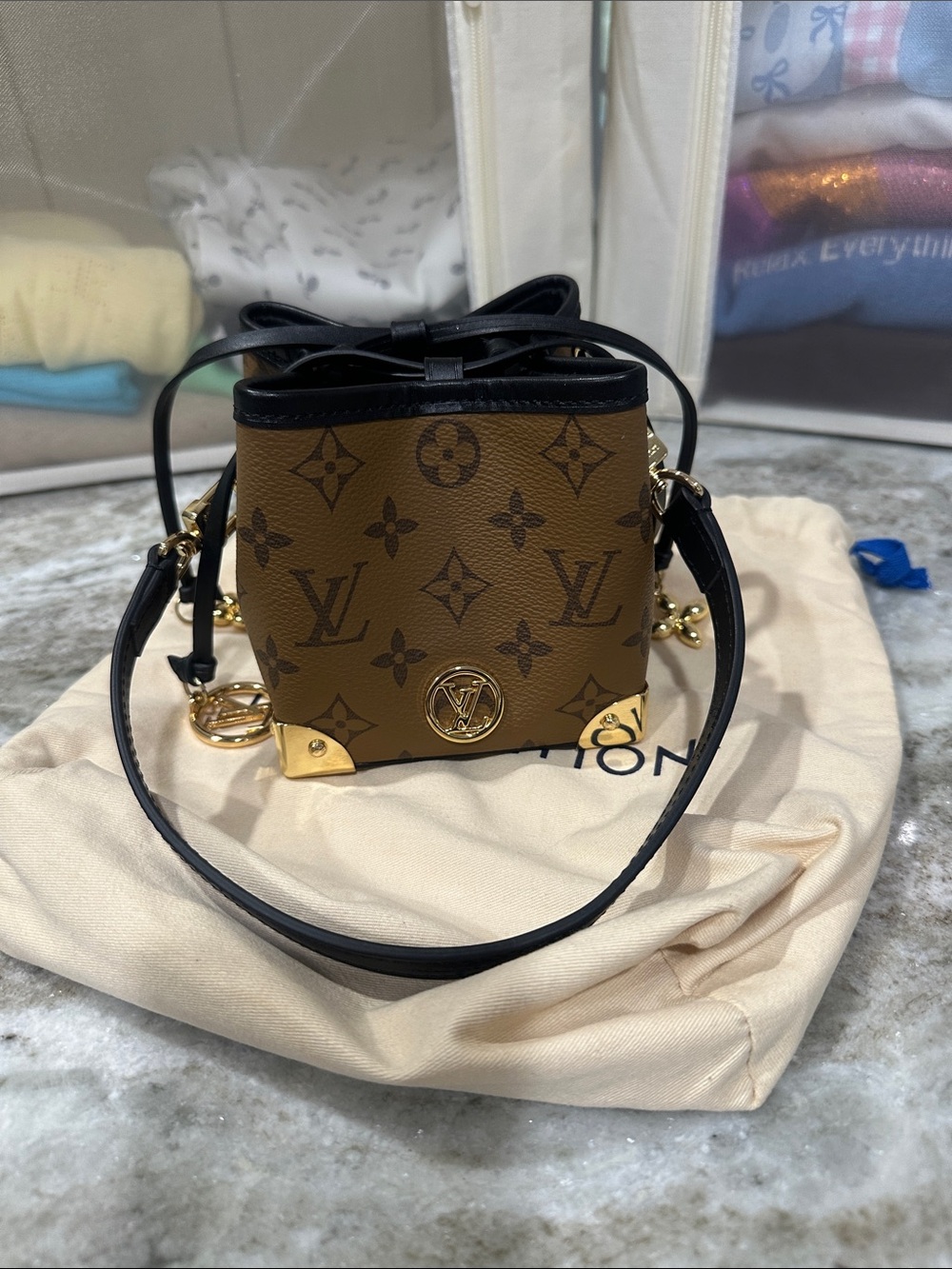 Mini Monogram Bucket Bag in Brown and Black with gold charms and gold Hardware